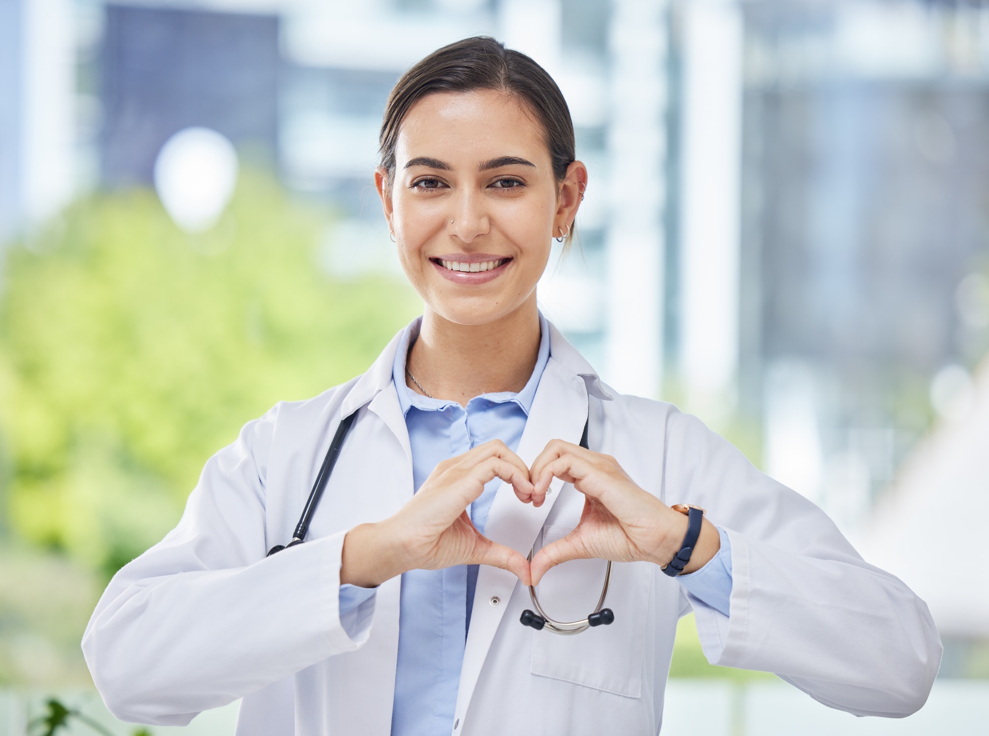 Heart, hand and icon with happy doctor in medical clinic or hospital. Happy, health and safety in t