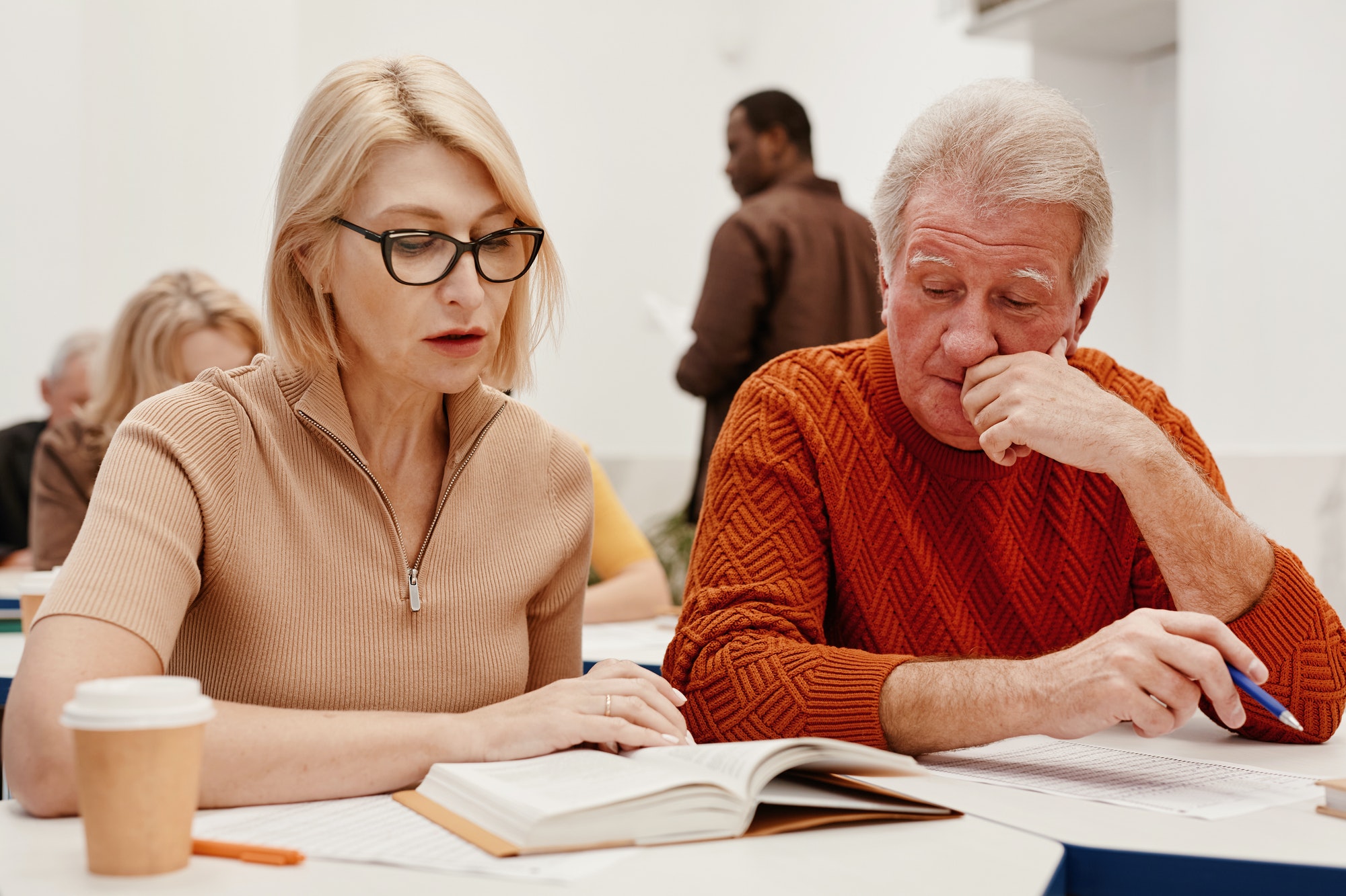 Senior couple reading a book at training